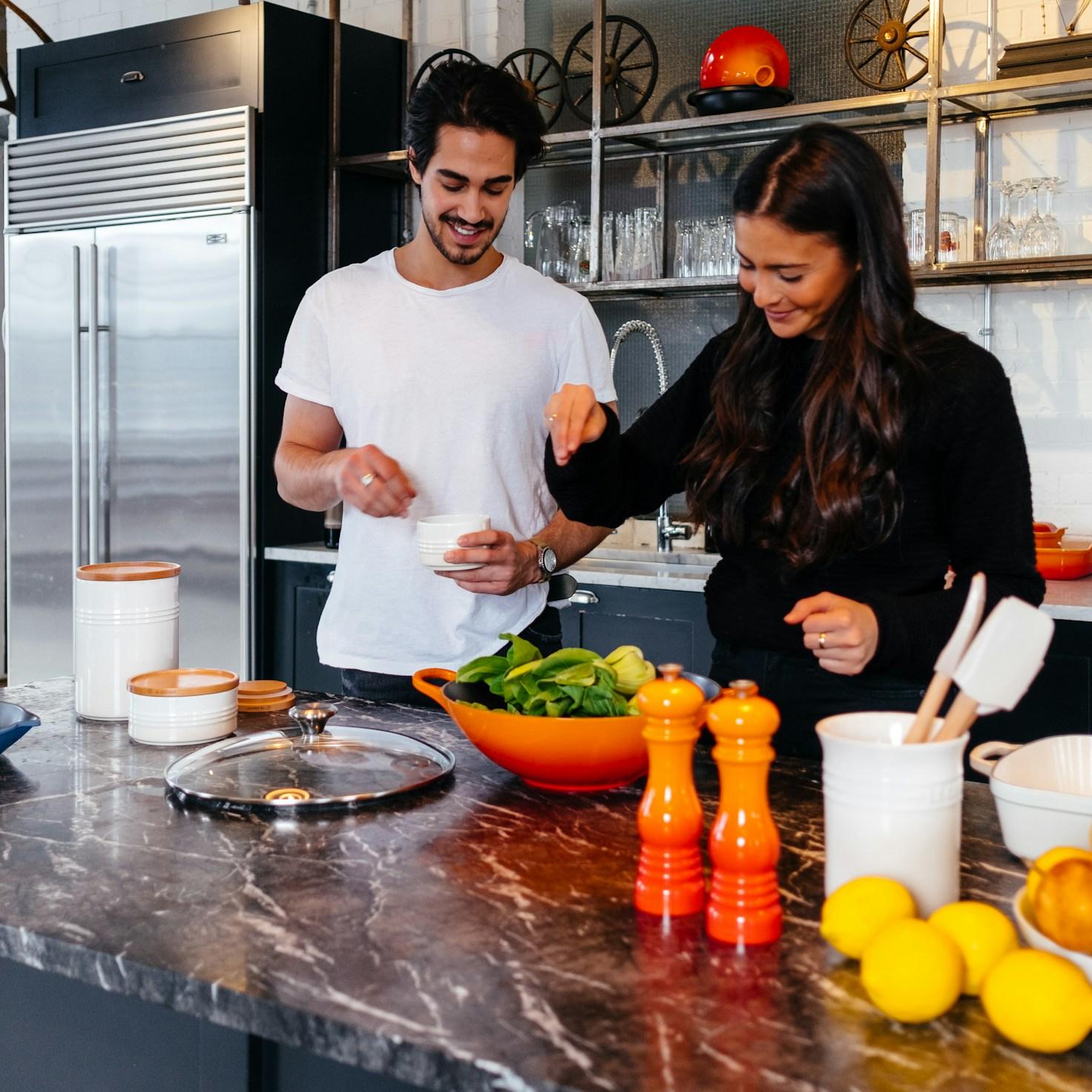 Community members collaborating in a modern kitchen space, sharing recipes and cooking techniques